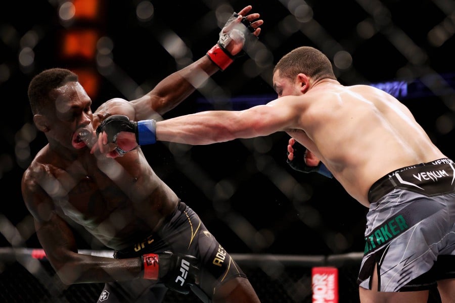  Robert Whittaker punches Israel Adesanya in their middleweight championship fight during UFC 271 at Toyota Center on February 12, 2022 in Houston, Texas. - AFP PIC