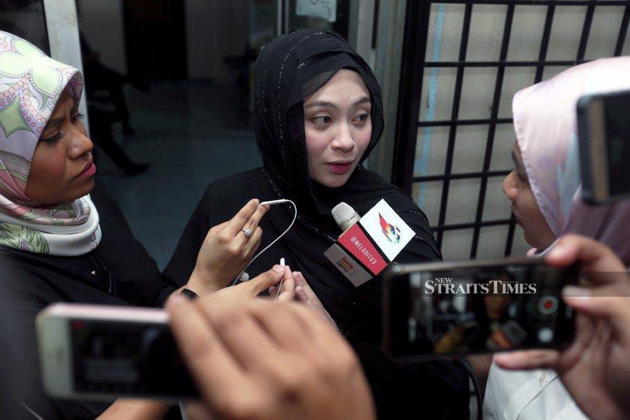  A file pic dated Oct 9, 2019, shows Adira Suhaimi speaking to reporters at Gombak Barat Lower Syariah Court in Rawang, after filing for a divorce against her husband. - NSTP file pic