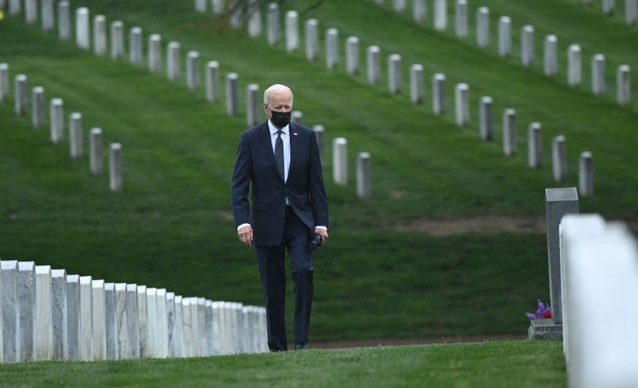 US President Joe Biden walks through Arlington National cemetery to honour fallen veterans of Afghan conflict in Arlington, Virginia. -AFP pic