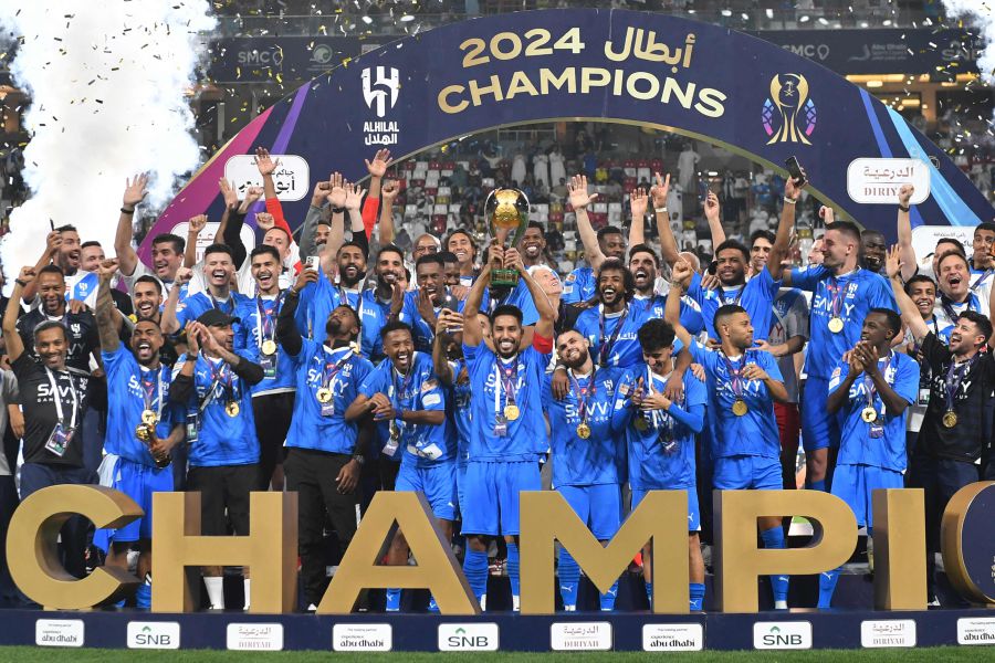 Hilal's players celebrate with the trophy after winning the Saudi Super Cup final football match between Al-Ittihad and Al-Hilal at the Mohammed bin Zayed Stadium in Abu Dhabi. - AFP pic