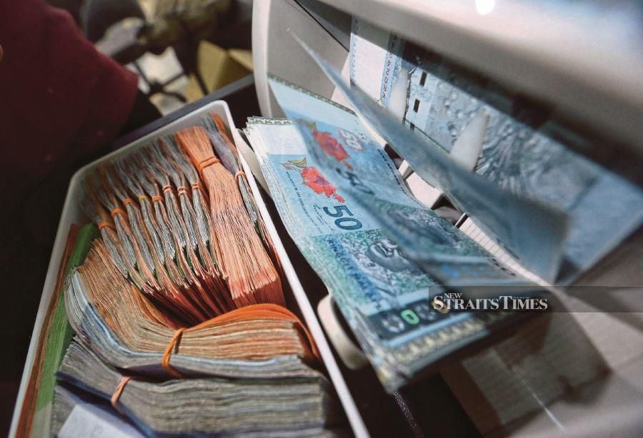 The ringgit opened higher against the US dollar today as cautious global economic sentiment prompted some investors to shift towards emerging currencies, including the ringgit, a dealer said. STR/ ZULFADHLI ZULKIFLI.