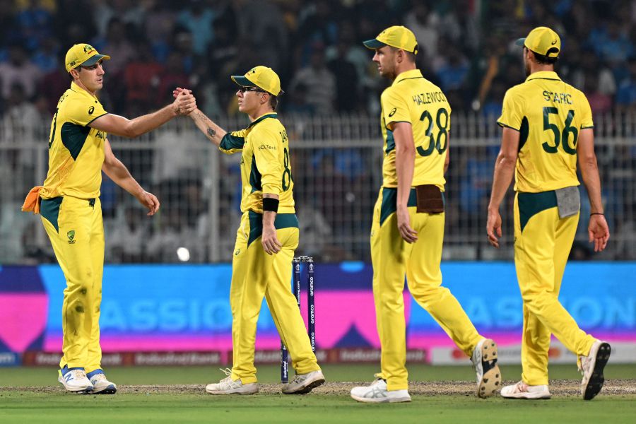 Australia's Adam Zampa (2nd left) greets captain Pat Cummins (Left) at the end of the first innings of the 2023 ICC Men's Cricket World Cup one-day international (ODI) second semi-final match between Australia and South Africa at the Eden Gardens in Kolkata. - AFP pic