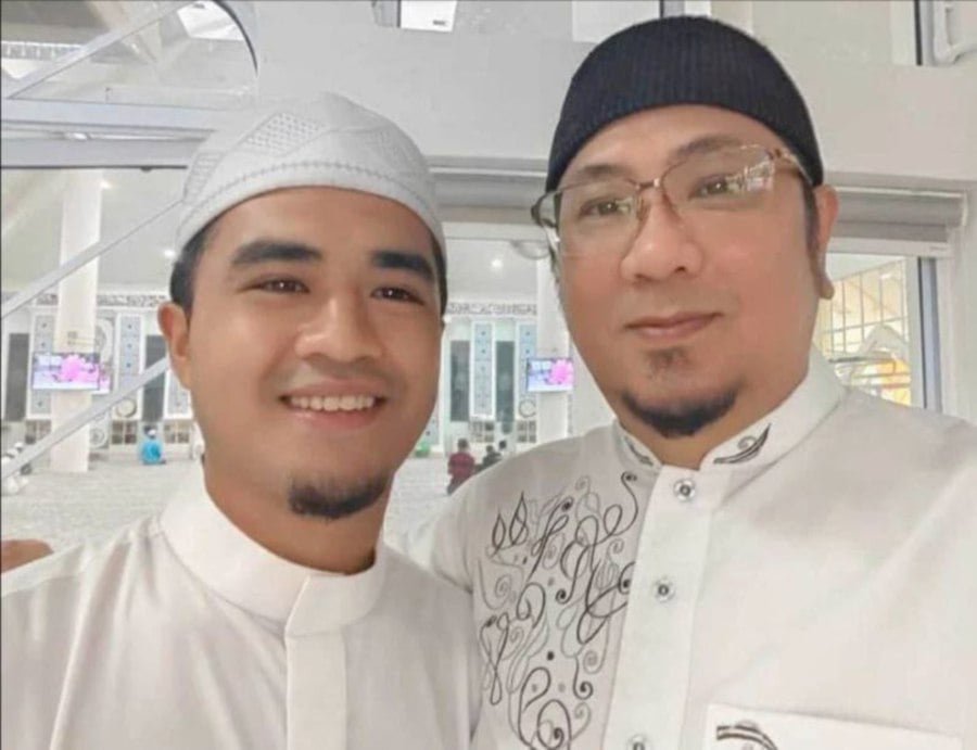 Azadan (right) with Nazrul’s son Alif at the recent tahlil session.