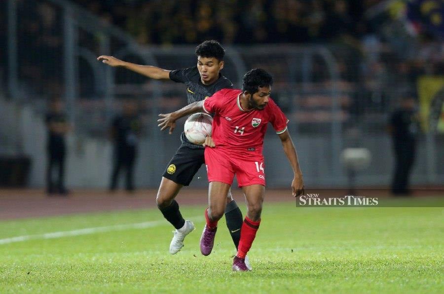 Footballer Azam Azmi Murad (left) has a foot, or a boot, so to speak, in two places. - NSTP file pic