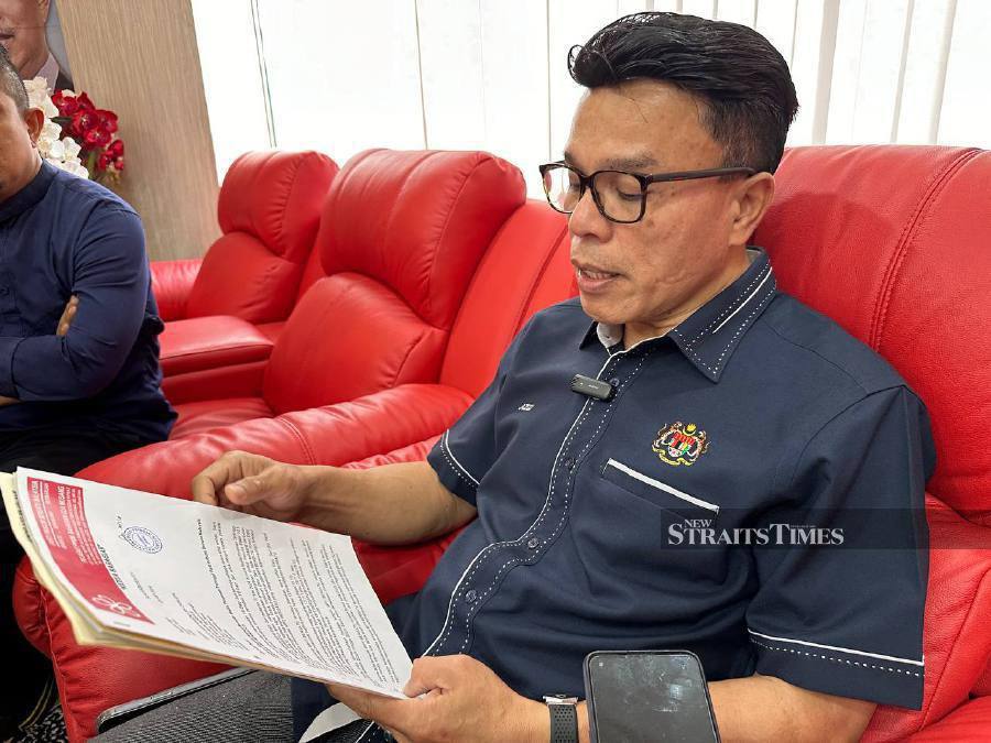 Former Nenggiri assemblyman Mohd Azizi Abu Naim with letters he had received and replied to, in which he had declared his loyalty to Bersatu. NSTP/PAYA LINDA YAHYA
