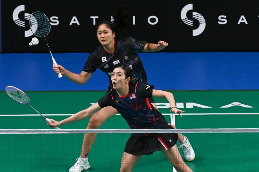 Malaysia's Lim Chiew Sien (top) and Lai Pei Jing compete against Hong Kong's Yeung Nga Ting and Yeung Pui Lam during their women's doubles match at the Australia Open badminton tournament in Sydney on June 15, 2024. - AFP PIC