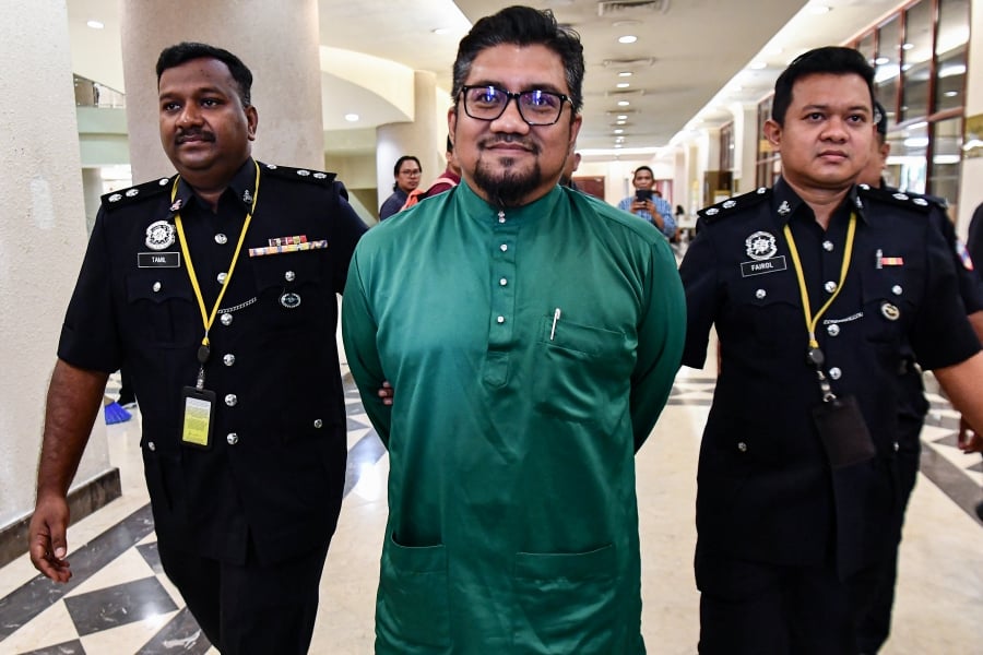 Earlier, Badrul Hisham, clad in a green baju Melayu and in handcuffs, arrived at the court complex at about 9.20am. - BERNAMA PIC