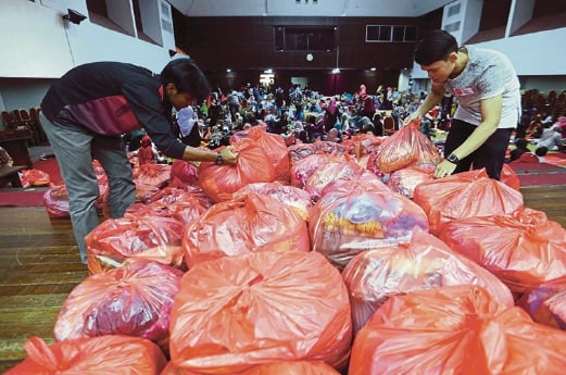 The packed clothes are labelled clearly for easy distribution. Pix by MOHD KHAIRUL HELMY MOHD DIN. 