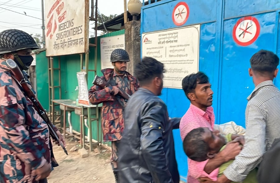 Local people carry a bullet wounded man for emergency aid at Médecins Sans Frontières (MSF) in Ukhia, after a military crackdown at the Bangladesh-Myanmar border. (Photo by Tanbir MIRAJ / AFP)