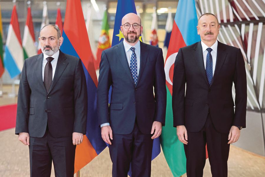 (From left) Armenian Prime Minister Nikol Pashinyan, President of the European Council Charles Michel, and Azerbaijan's President Ilham Aliyev, pose for an official picture before their meeting at the European Council in Brussels on April 6, 2022, for EU-mediated talks amid renewed tensions over the disputed region of Nagorno-Karabakh. -  (Photo by François WALSCHAERTS / AFP)