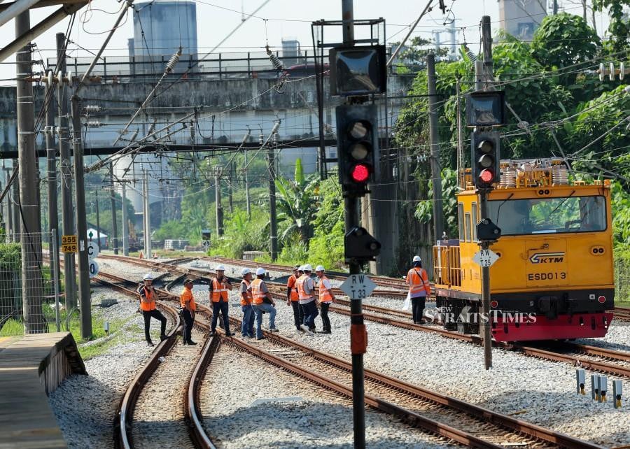 This Dec 13 pic shows workers clearing the tracks following the construction crane collapse in Rawang. - BERNAMA PIC