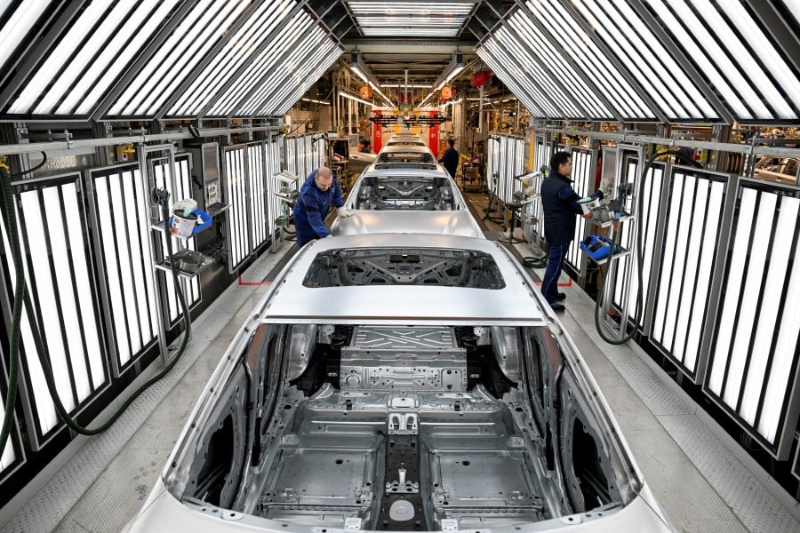 BMW is putting up four buildings including a new vehicle assembly line and body shop, and has moved traditional engine manufacturing to Great Britain and Austria, with 1,200 employees retrained or moved to other locations. -- Reuters photo