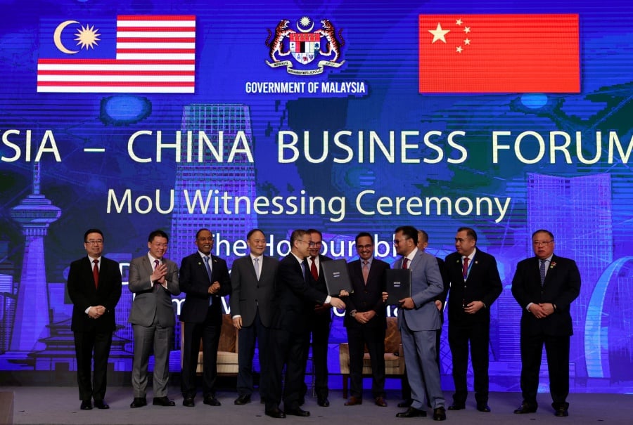 Prime Minister Datuk Seri Anwar Ibrahim (fifth, right) witnessed the signing ceremony of the Heads of Agreement between DRB-Hicom Berhad and Zhejiang Geely Holding Group Co., Ltd during the Malaysia-China Business Forum 2023. - BERNAMA Pic