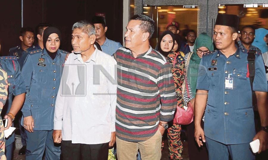 (File pix) Photo shows family members of fireman Muhammad Adib Mohd Kassim at Kuala Lumpur last night. Pix by NSTP/Saifullizan Tamadi 