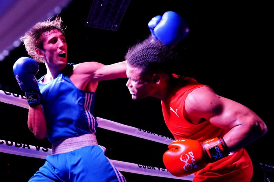 Cuban Erislandy Alvarez fights against France's Sofiane Oumiha during a boxing friendly match in Varadero, Cuba. - Reuters pic