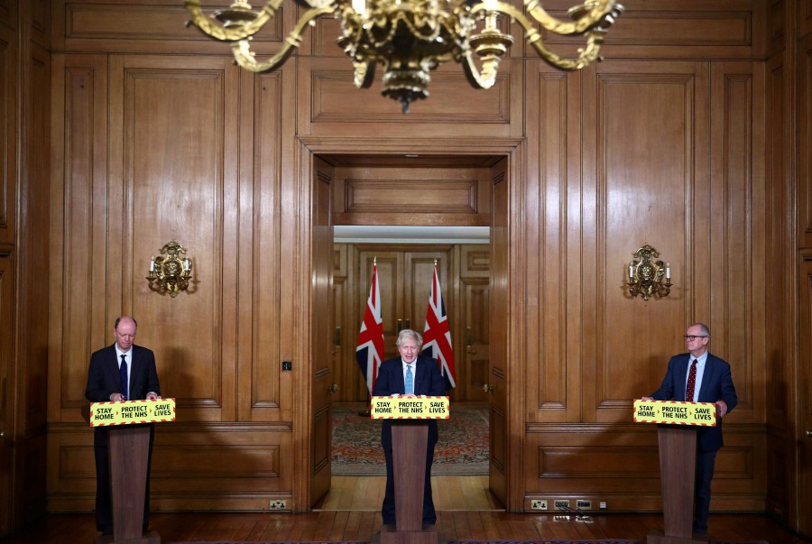 Britain's Prime Minister Boris Johnson(C), Britain's Chief Scientific Adviser Patrick Vallance (R), and Britain's Chief Medical Officer for England Chris Whitty take part in a virtual press conference inside 10 Downing Street in central London following the introduction of a nationwide coronavirus lockdown on January 5, 2021. (Photo by HANNAH MCKAY / POOL / AFP)