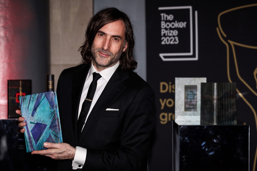 Irish writter Paul Lynch and Booker Prize 2023 shortlisted author poses with his specially bound book copy "Prophet Song" on the red carpet upon arrival for the Booker Prize Award announcement ceremony, at the Old Billingsgate, in central London. (Photo by Adrian DENNIS / AFP)
