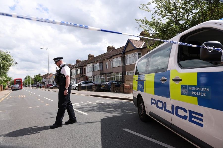 A police officer stands on duty at a cordon of a crime scene in Hainault, east of London where a 36-year-old man wielding a sword was arrested following an attack on members of the public and two police officers.(Photo by Adrian DENNIS / AFP)