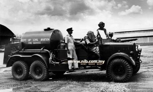 1954: Inside the cylindrical tank are 3,000 gallons of foam - one of the most effective fire fighters. This is one of the four tenders which stand by at the Kuala Lumpur Airport in case of air crash fires. The fire fighting squad is made up of the Department of Civil Aviation firemen and Royal Air Force personnel.