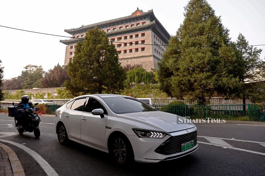 A BYD electric vehicle (EV) Qin moves on a street in Beijing, China October 31, 2023. REUTERS/Tingshu Wang/File Photo