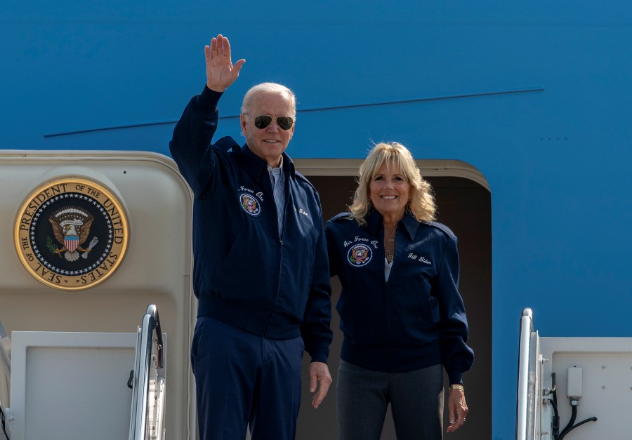 U.S. President Joe Biden waves as first lady Jill Biden watches standing at the top of the steps of Air Force One before boarding at Andrews Air Force Base, Md., Saturday. President Biden said during and interview broadcasted on Sunday, Sept. 18, 2022, that U.S. forces would defend Taiwan if China tries to invade the self-ruled island claimed by Beijing as part of its territory, adding to displays of official American support for the island democracy in the face of Chinese intimidation. - AP pic