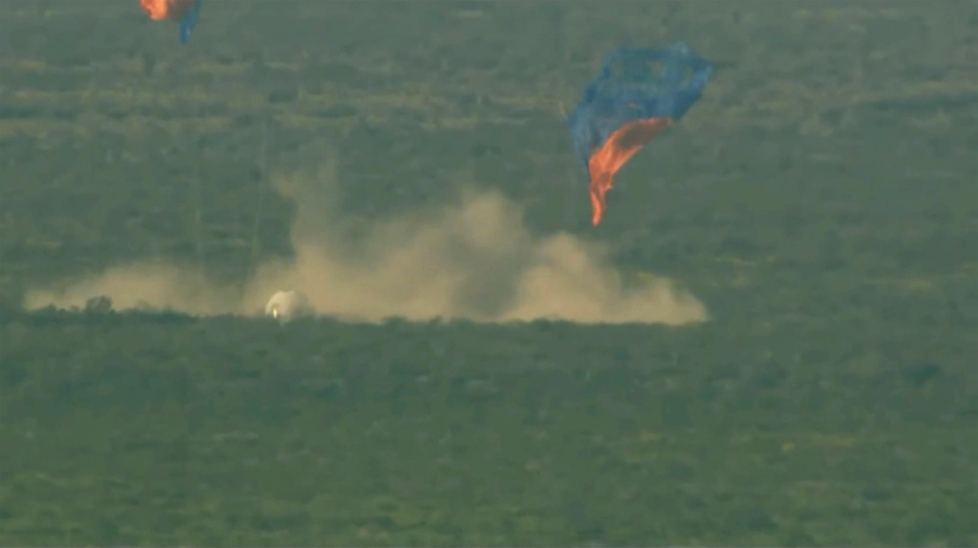 This image provided by Blue Origin shows a capsule containing science experiments after a launch failure and parachuting onto the desert floor on Monday. (Blue Origin via AP)