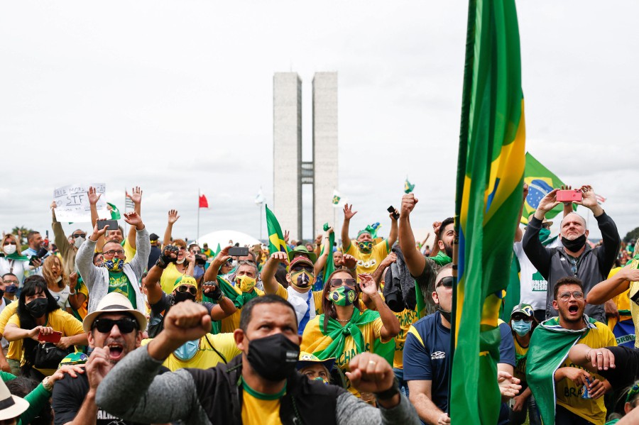 People take part in a demonstration to show their support for Brazilian President Jair Bolsonaro amid the COVID-19 novel coronavirus disease pandemic, in Brasilia. - AFP pic