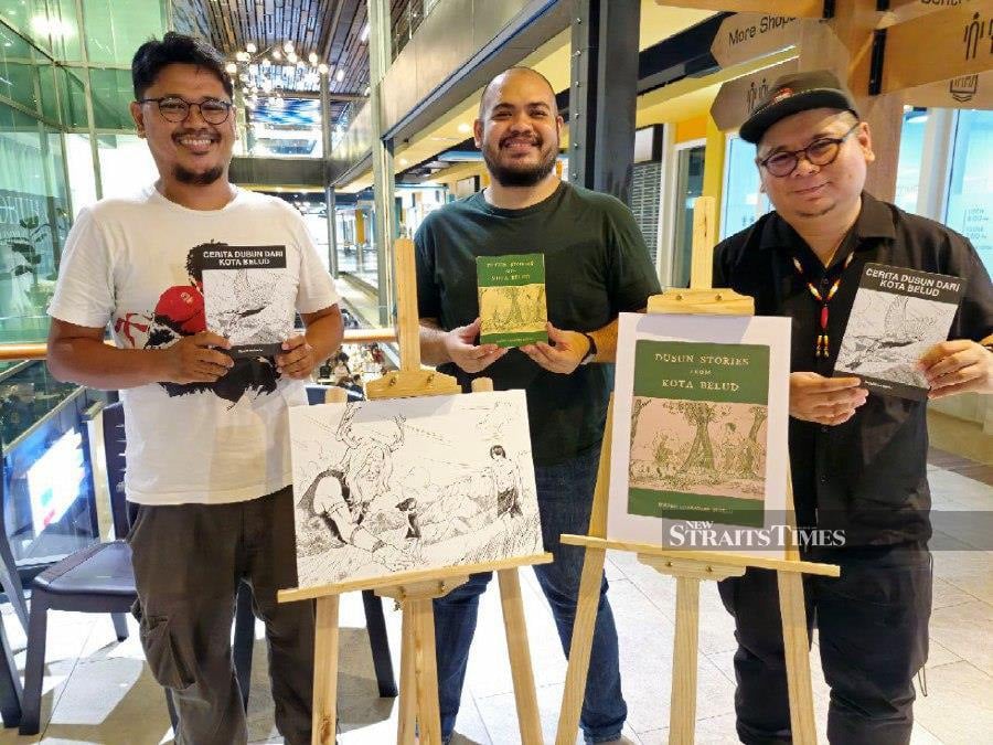 Bundusan Books founder Jesse Joy (centre) during the launching of its first publication "Cerita Dusun dari Kota Belud" in conjunction with Jesselton Artisan Market 7th anniversary here yesterday. Present are the book editor Ricardo Unto (right) and illustrator Anas Hussain (left). - NSTP/ OLIVIA MIWIL