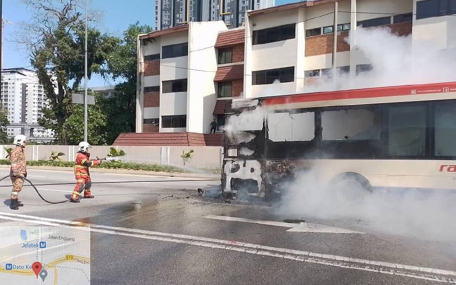 An intercity bus travelling near Menara Great Eastern on Jalan Ampang suddenly caught fire in the middle of the road at 10.48am this morning. - Pic courtesy of Fire and Rescue Dept