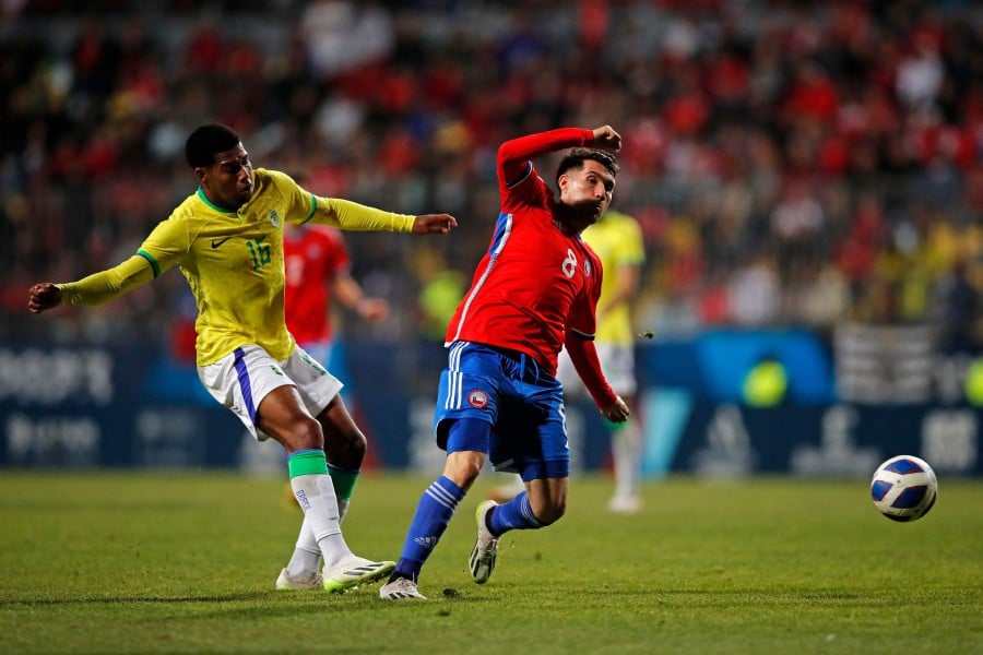 Brazil's forward Thauan Lara (left) and Chile's midfielder Cesar Fuentes vie for the ball during the men's team gold medal football match between Chile and Brazil at the Pan American Games Santiago 2023, in the Sausalito stadium, Viña del Mar, Chile. - AFP pic