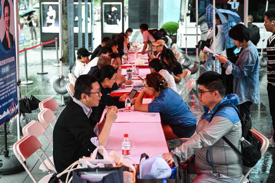 People visit a job fair in in Shanghai on May 31, 2024. AFP
