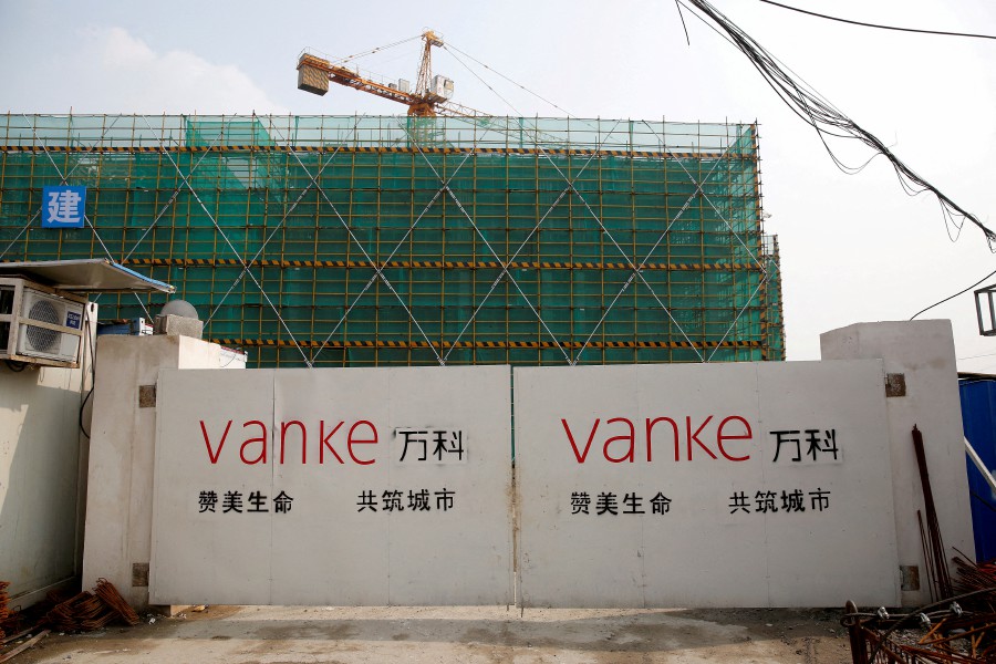 FILE PHOTO: The logo of property developer China Vanke is seen on gates at a construction site in Shanghai, China, March 21, 2017. REUTERS/Aly Song/File Photo