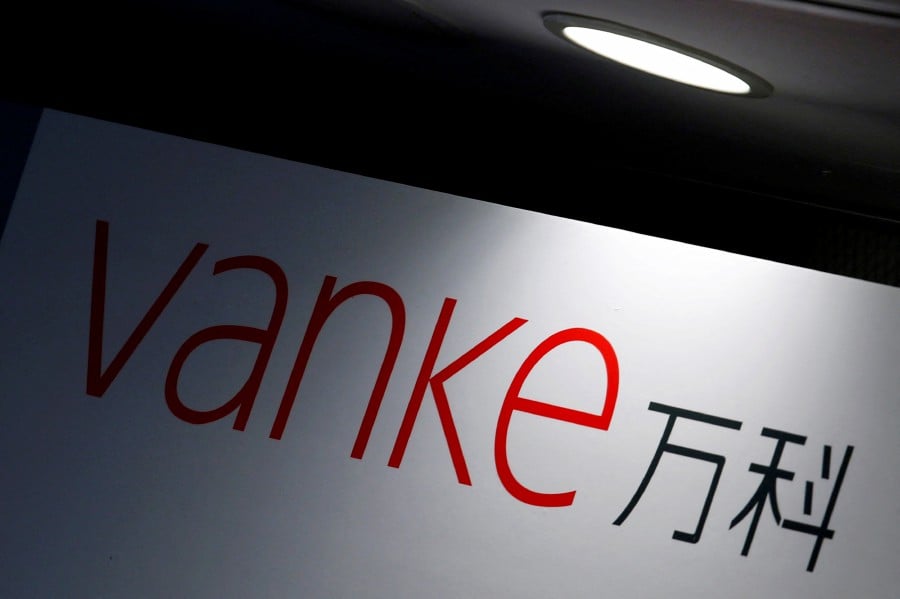 FILE PHOTO: The company logo of China Vanke is displayed at a news conference announcing the property developer's interim results in Hong Kong, China August 22, 2016. REUTERS/Bobby Yip/File Photo