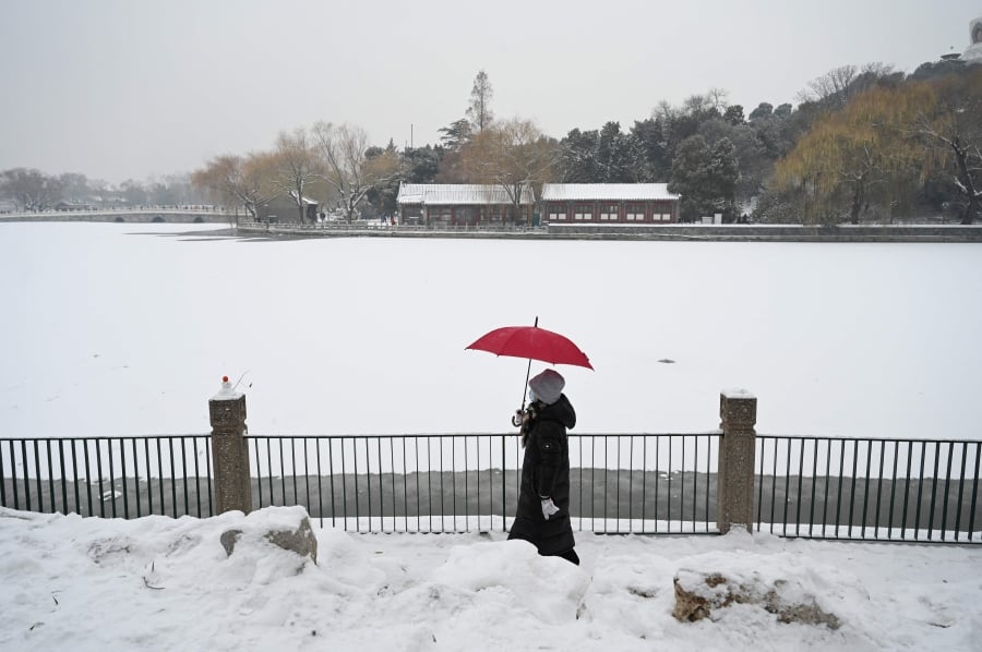 Gripping cold weather swept across major sections of China on Thursday while many areas in the south will see sharp drops in temperatures over the next few days. (Photo by GREG BAKER / AFP)