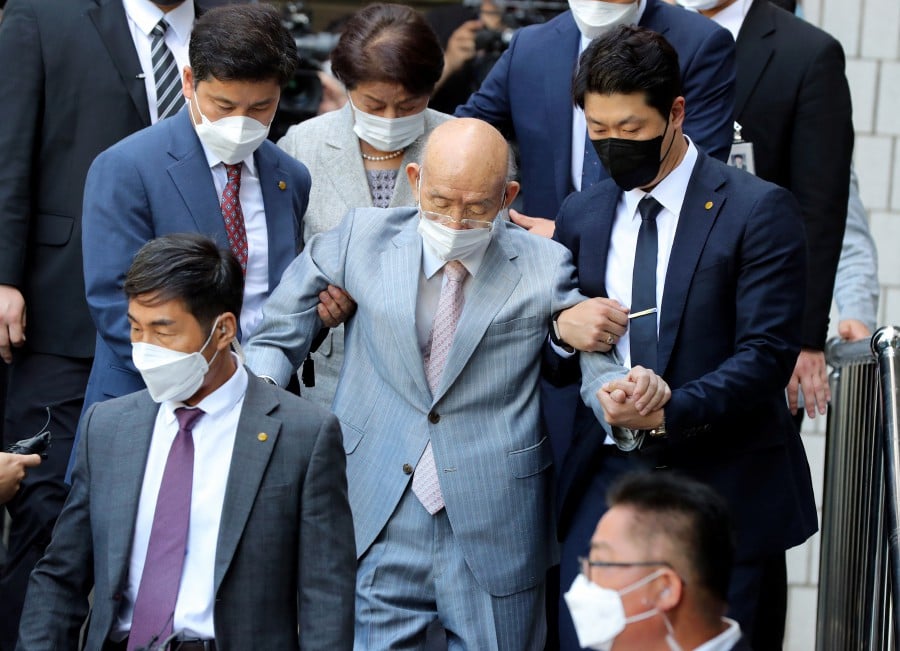 Former President Chun Doo-hwan (C), escorted by security guards, leaves a district court in the southwestern city of Gwangju, South Korea, 09 August 2021 (issued 23 November 2021), after attending an appellate trial on the charge of libel. Chun, a general-turned strongman who seized power through a 1979 military coup and ruthlessly quelled a pro-democracy civil uprising in the city the following year, died on 23 November 2021, aides said. He was 90. - EPA pic 