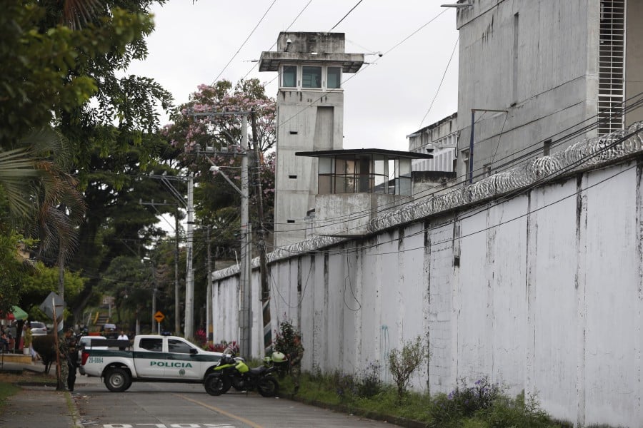 Members of the Police guard the exterior of the Tulua prison, in Tulua, department of Valle del Cauca, Colombia, 28 June 2022. The number of deaths in the fire that occurred early Tuesday in the prison of the Colombian city of Tulua (southwest), amounted to 51, official sources reported. The tragedy apparently began with a fight that escalated into a riot in which some inmates set mattresses on fire, sparking a fire that spread through much of the medium-security prison. - EPA pic