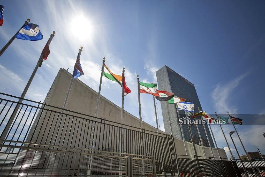 Flags fly outside the the United Nations (UN) headquarters in New York. - BLOOMBERG photo