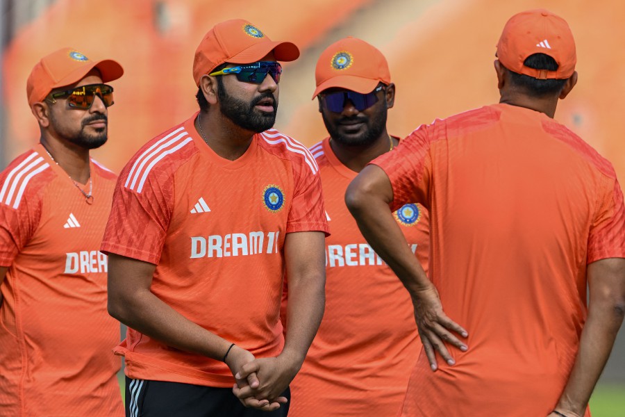 India’s captain Rohit Sharma (left) interacts with support staff during a practice session at the Narendra Modi Stadium in Ahmedabad, ahead of the 2023 ICC Men's Cricket World Cup one-day international (ODI) final match against Australia on November 19. - AFP pic