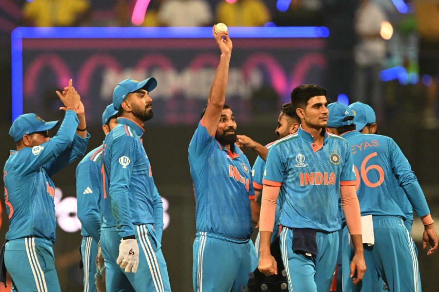 India's Mohammed Shami (centre) celebrates with teammates after taking the wicket of Sri Lanka's Kasun Rajitha during the 2023 ICC Men's Cricket World Cup one-day international (ODI) match between India and Sri Lanka at the Wankhede Stadium in Mumbai. - AFP pic
