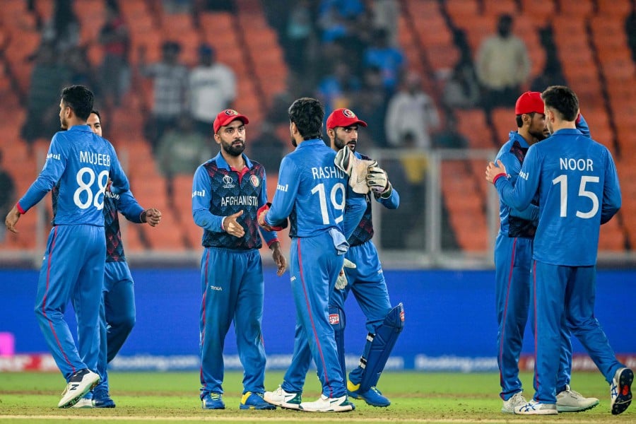 Afghanistan's players greet each other at the end of the 2023 ICC Men's Cricket World Cup one-day international (ODI) match between South Africa and Afghanistan at the Narendra Modi Stadium in Ahmedabad on November 10, 2023. AFP PIC
