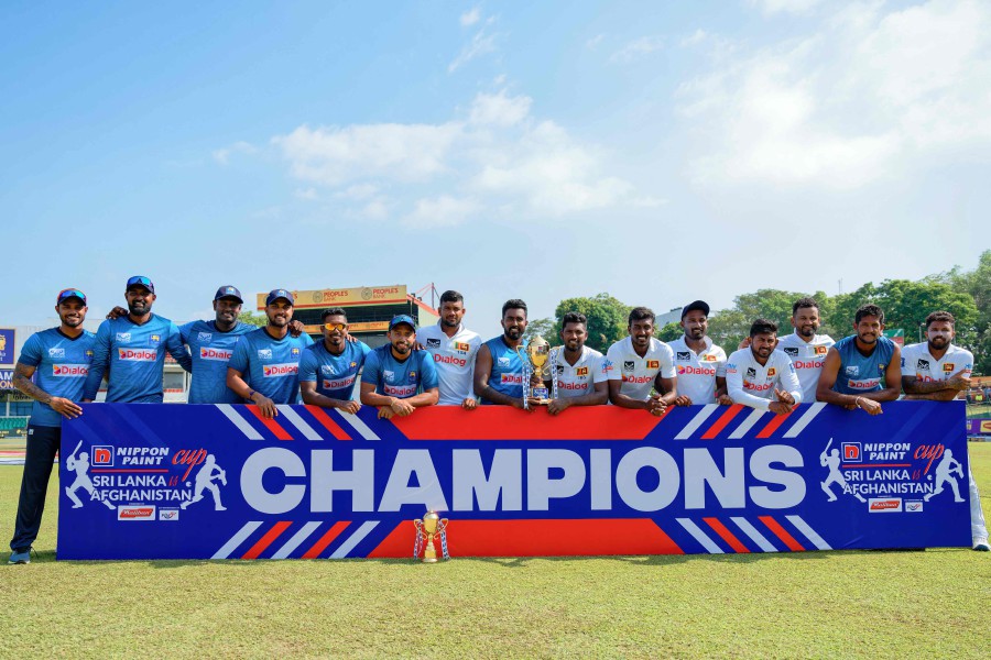 Sri Lankan players pose with the series trophy after their victory at the one-off Test cricket match between Sri Lanka and Afghanistan at the Sinhalese Sports Club (SSC) in Colombo on February 5, 2024. AFP PIC