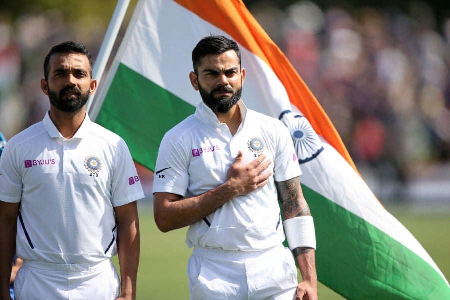 India's Virat Kohli and Ajinkya Rahane line up during the national anthems before the match. REUTERS PIC