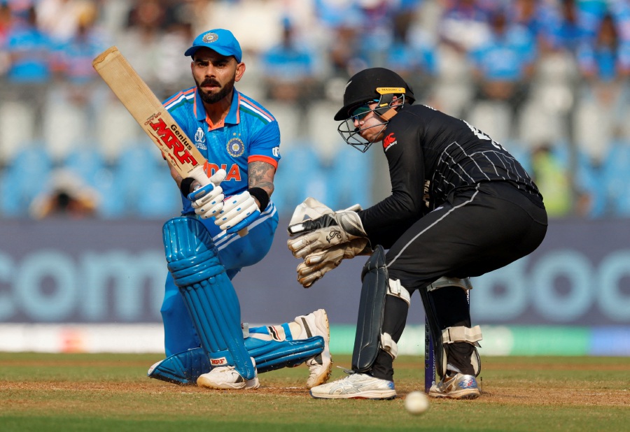 India's Virat Kohli in action as New Zealand's Tom Latham looks on. - REUTERS Pic