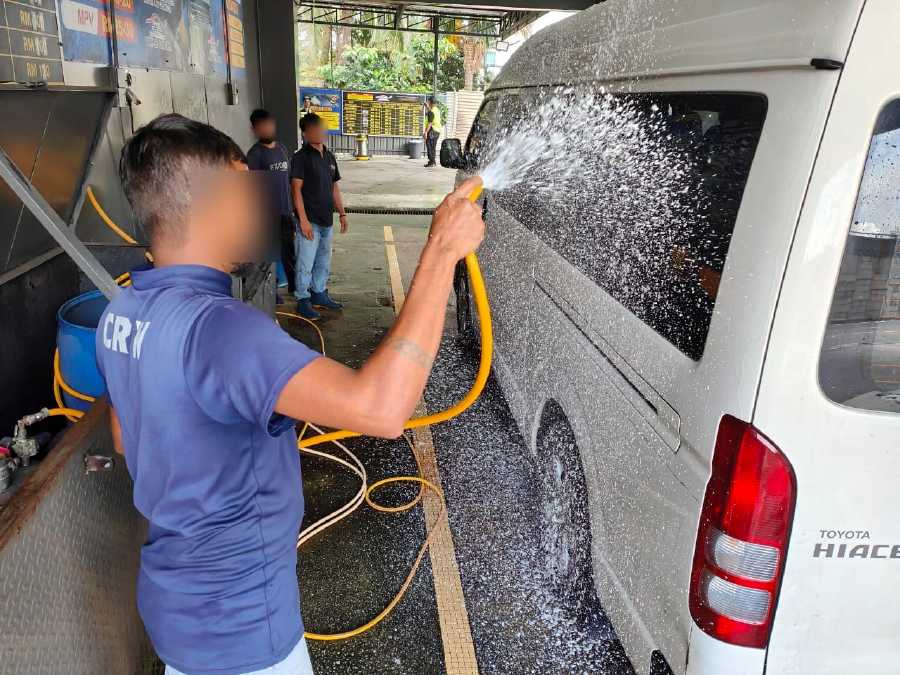 The Immigration Department has detained 12 foreign workers offering car wash services at a petrol station on a highway in Petaling Jaya. - Pic courtesy from Immigration Dept 