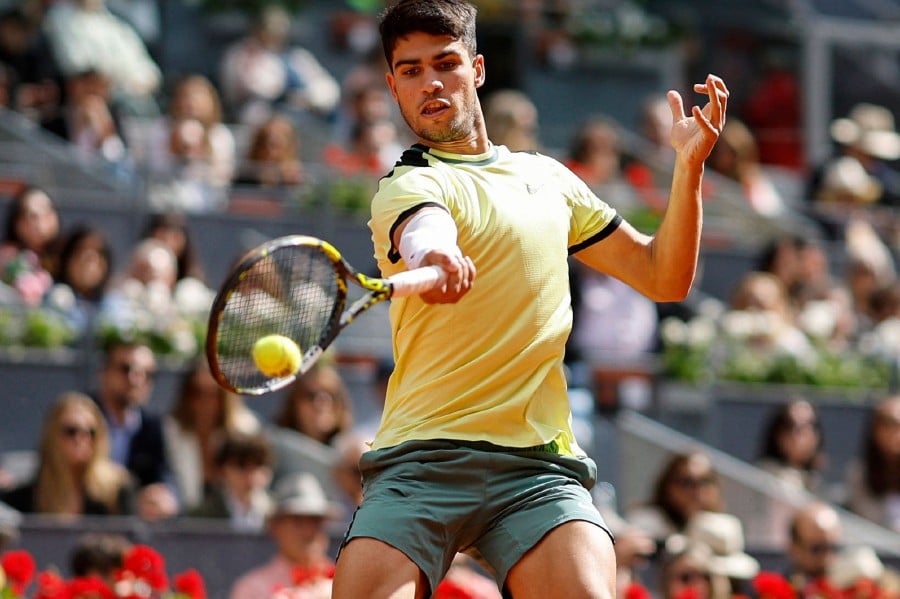 Spain's Carlos Alcaraz returns to Brazil's Thiago Seyboth Wild during the third round of the 2024 ATP Tour Madrid Open tournament tennis match at Caja Magica in Madrid on April 28, 2024. - AFP pic