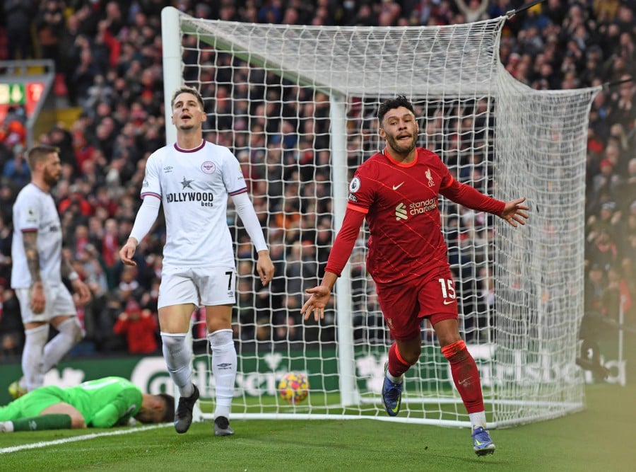 Liverpool's English midfielder Alex Oxlade-Chamberlain (R) celebrates scoring his team's second goal against Brentford at Anfield in Liverpool. -AFP PIC