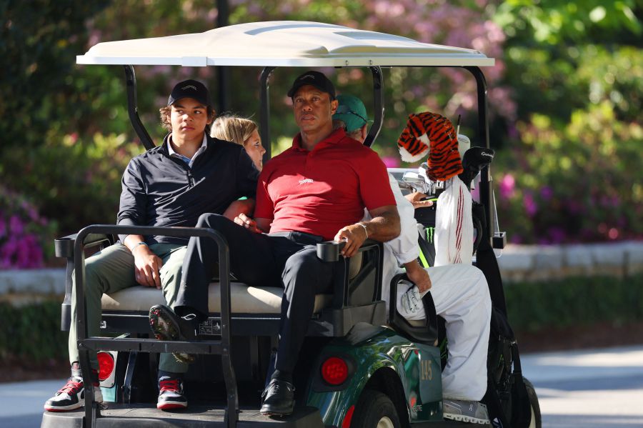 Tiger Woods of the United States and his son Charlie Woods depart the practice area in a cart during the final round of the 2024 Masters Tournament at Augusta National Golf Club on April 14, 2024 in Augusta, Georgia. - AFP PIC