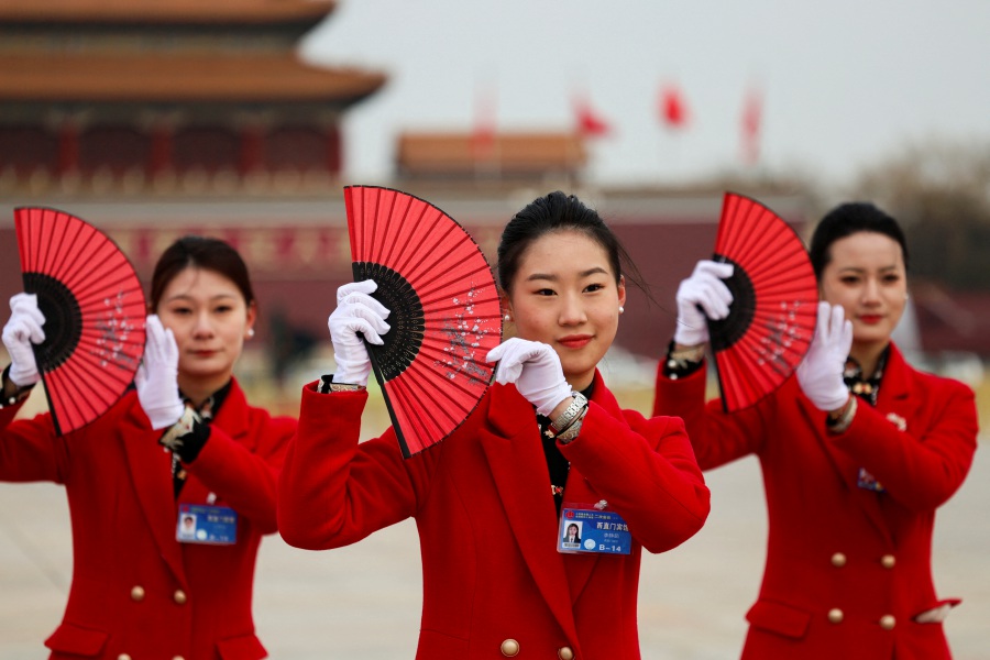 Attendants practice for a dance on the day of the opening session of the Chinese People's Political Consultative Conference (CPPCC), at Tiananmen Square, in Beijing, China. - Reuters pic