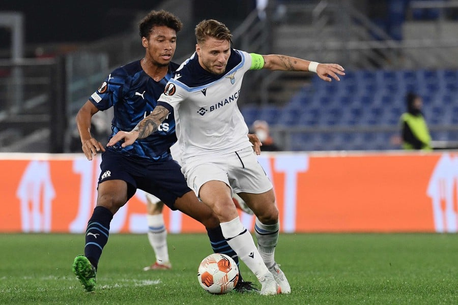 Lazio's Italian forward Ciro Immobile (Front) works around Marseille's French defender Boubacar Kamara during the UEFA Europa League Group E Football match between Lazio and Olympique de Marseille on October 21, 2021 at the Olympic stadium in Rome. - AFP PIC