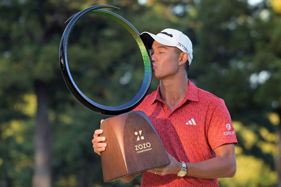 Collin Morikawa of the US kisses his victory trophy at the awarding ceremony of the Zozo Championships PGA golf tournament at the Narashino Country Club in Inzai, Chiba prefecture. - AFP pic